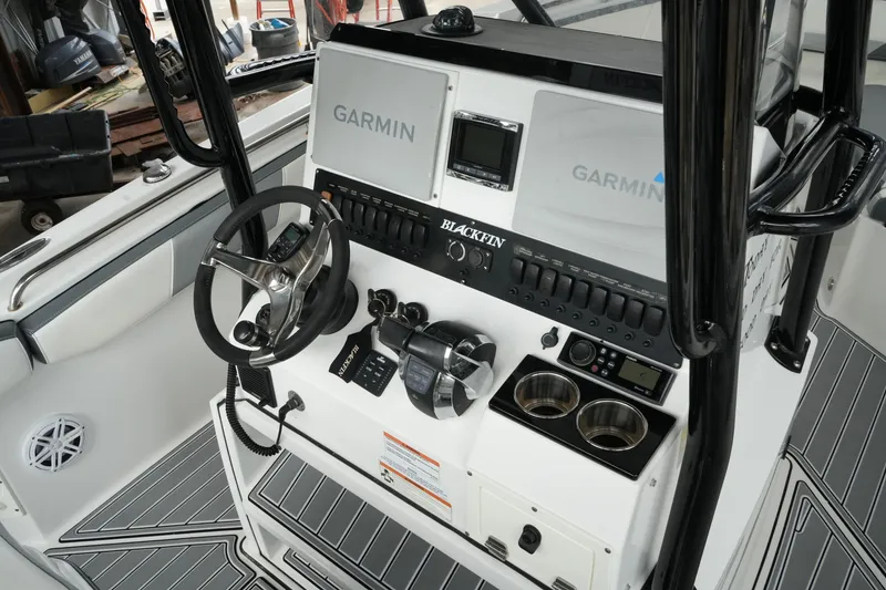 Slide: The Image of 2019 Blackfin 242 CC boat dashboard with Garmin navigation system and steering wheel. - 53