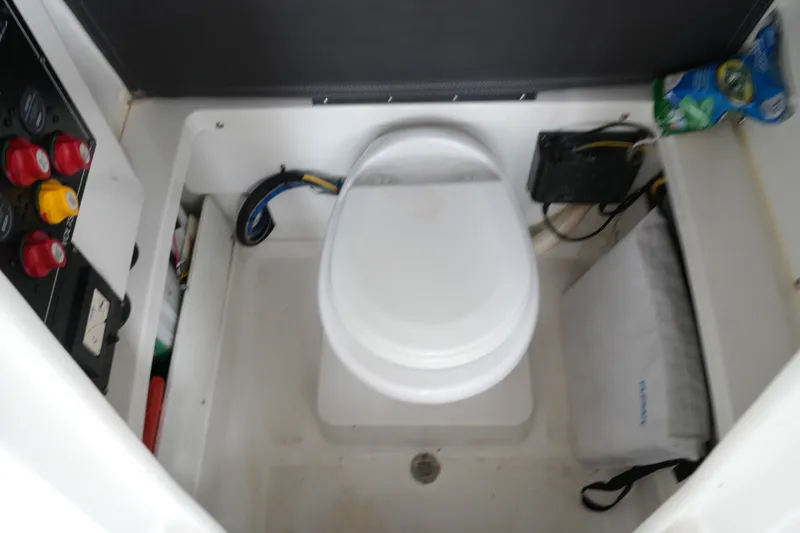 Slide: The Image of Boat toilet in a 2019 Blackfin 242 CC, featuring control panel and storage. - 46