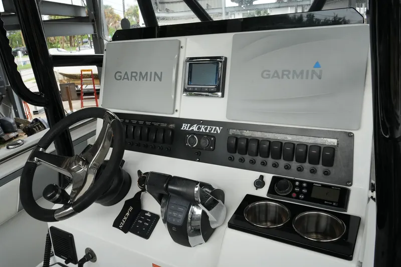 Slide: The Image of 2019 Blackfin 242 CC boat dashboard with Garmin navigation system and controls. - 34