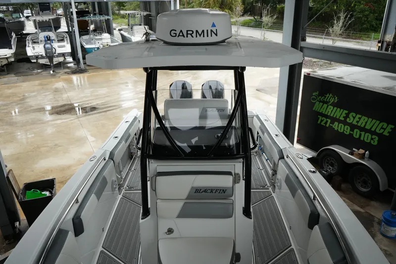 Slide: The Image of 2019 Blackfin 242 CC boat with Garmin equipment in a marine service area. - 21