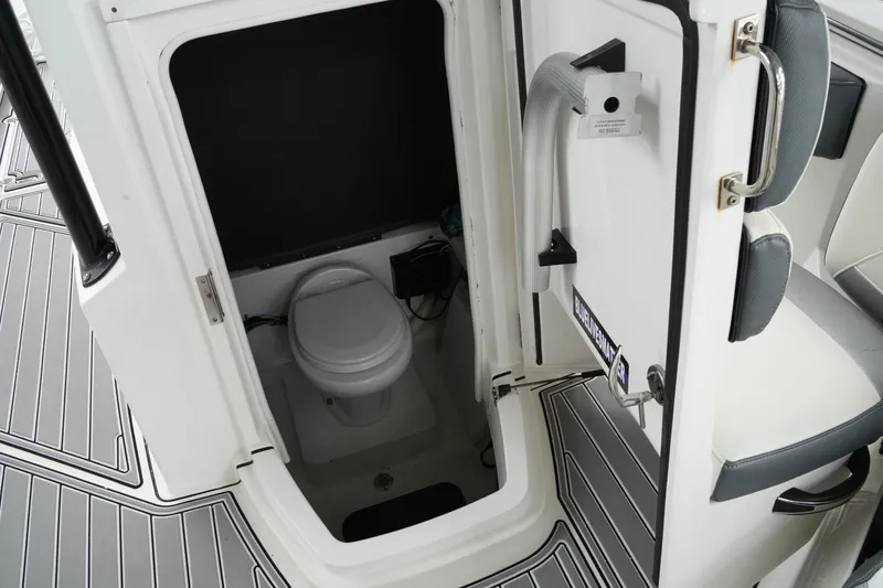 Slide: The Image of 2019 Blackfin 242 CC boat interior with compact marine toilet. - 22