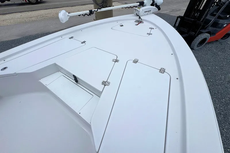 Slide: The Image of 2019 Sportsman Tournament 214 SBX Bay Boat deck with storage compartments and trolling motor. - 19