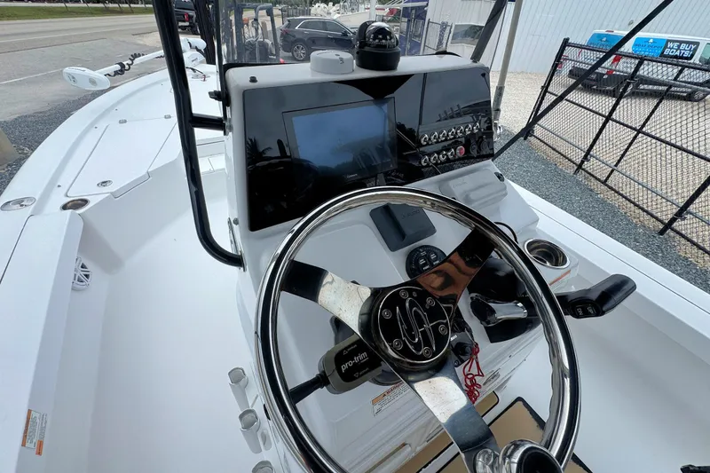 Slide: The Image of 2019 Sportsman Tournament 214 SBX Bay Boat dashboard with steering wheel and controls. - 16