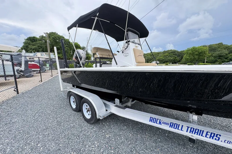 Slide: The Image of 2019 Sportsman Tournament 214 SBX Bay Boat on trailer, parked outdoors. - 8