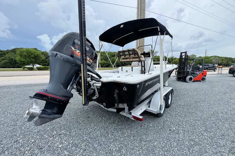 Slide: The Image of 2019 Sportsman Tournament 214 SBX Bay Boat on trailer, parked outdoors. - 2