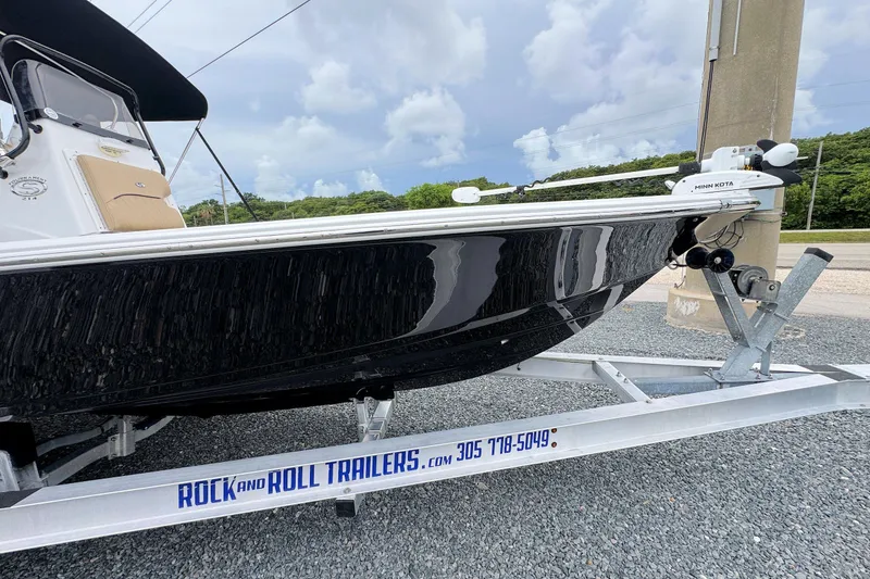 Slide: The Image of 2019 Sportsman Tournament 214 SBX Bay Boat on trailer, parked outdoors. - 6