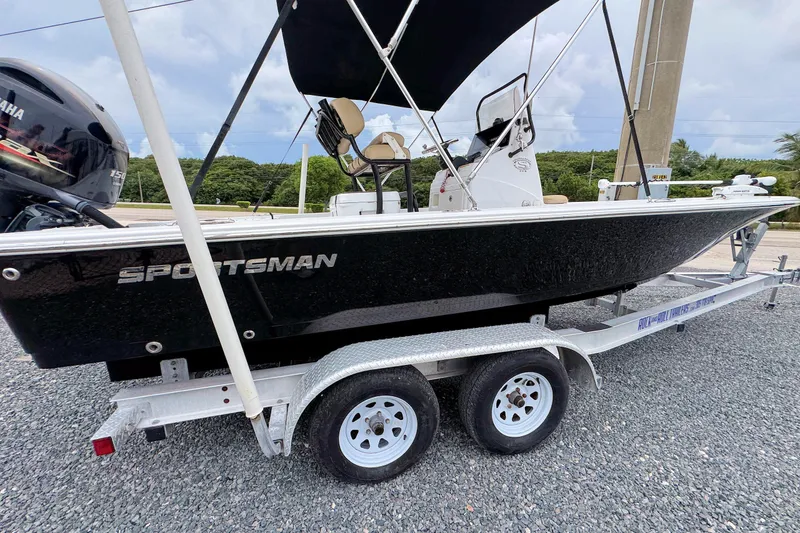 Slide: The Image of 2019 Sportsman Tournament 214 SBX Bay Boat on trailer, featuring sleek black design. - 3