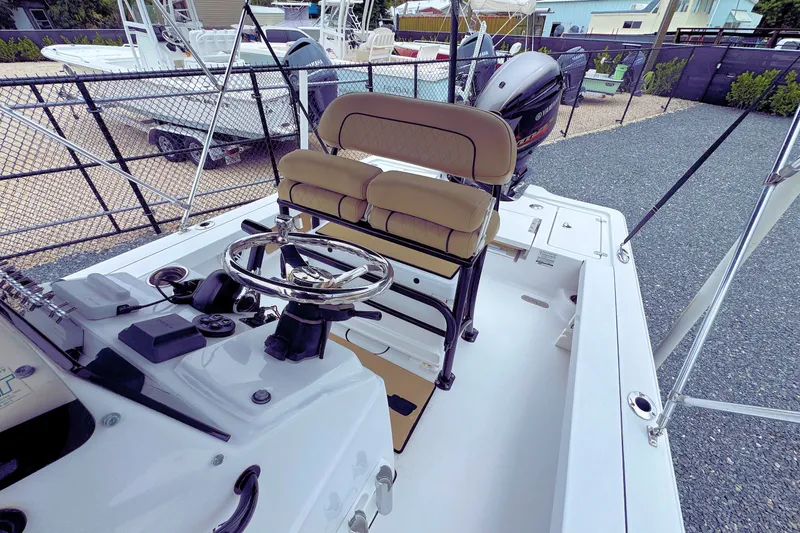 Slide: The Image of 2019 Sportsman Tournament 214 SBX Bay Boat interior with steering wheel and seating. - 9