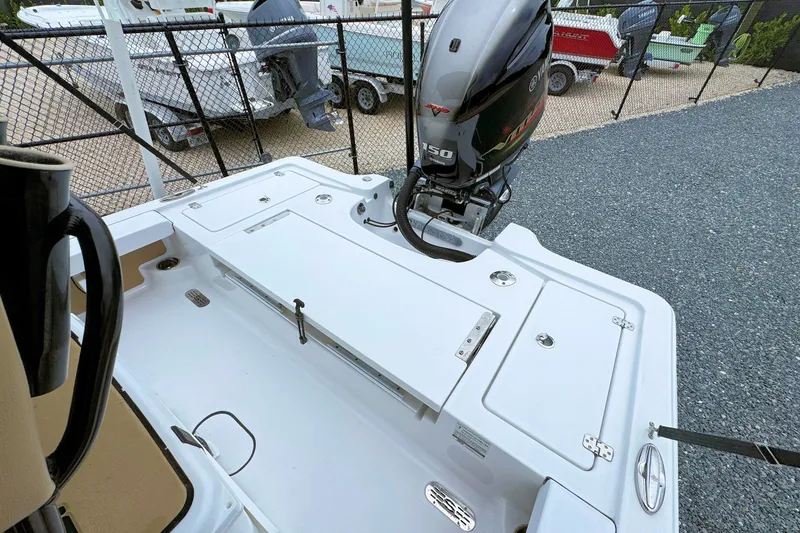 Slide: The Image of 2019 Sportsman Tournament 214 SBX Bay Boat with Yamaha 150 engine, docked outdoors. - 11