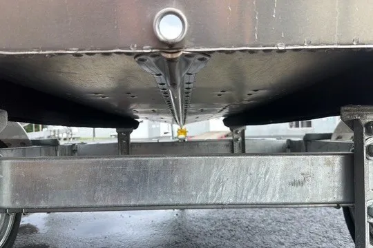 Slide: The Image of 2025 Lund WC-12 boat trailer underside, showcasing metal frame and construction details. - 10