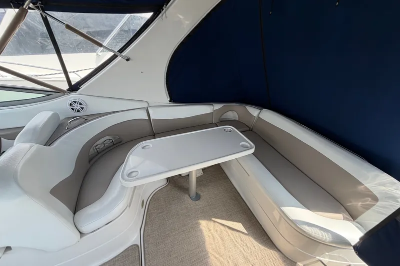 Slide: The Image of 2004 Wellcraft 3700 Martinique boat interior with cushioned seating and table. - 8