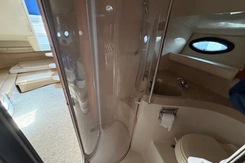 Slide: The Image of Interior of 2004 Wellcraft 3700 Martinique yacht, featuring bathroom and seating area. - 24