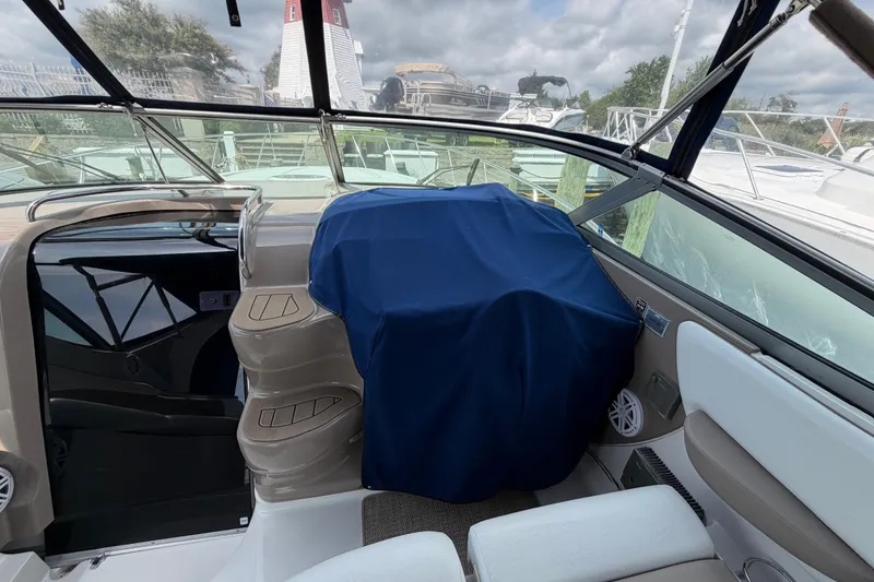 Slide: The Image of 2004 Wellcraft 3700 Martinique boat interior with covered dashboard and seating area. - 15