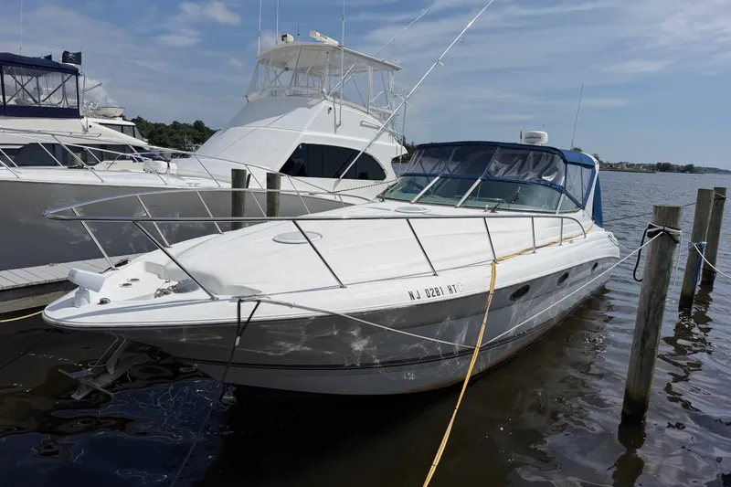 Slide: The Image of 2004 Wellcraft 3700 Martinique yacht docked at marina, clear sky, calm water. - 2
