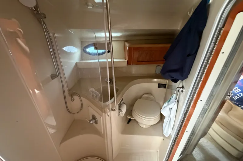 Slide: The Image of 2004 Wellcraft 3700 Martinique boat bathroom with shower, toilet, and storage cabinet. - 23