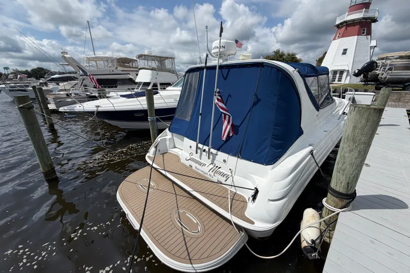 Slide: The Image of 2004 Wellcraft 3700 Martinique yacht docked near a lighthouse under cloudy skies. - 6