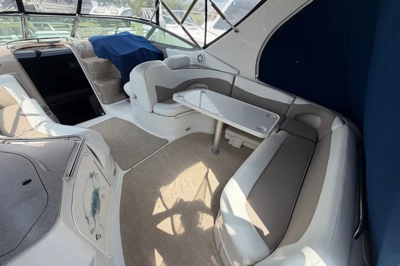 Slide: The Image of 2004 Wellcraft 3700 Martinique boat interior with seating and table setup. - 7