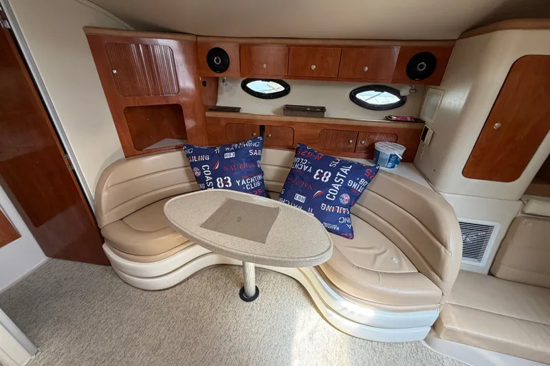 Slide: The Image of 2004 Wellcraft 3700 Martinique yacht interior with curved seating and nautical-themed pillows. - 20