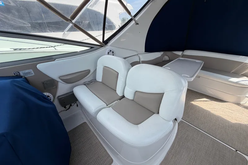 Slide: The Image of 2004 Wellcraft 3700 Martinique boat interior with cushioned seating and table. - 10
