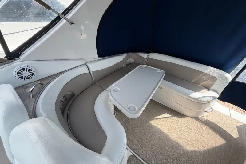 Slide: The Image of 2004 Wellcraft 3700 Martinique boat interior with cushioned seating and table. - 14