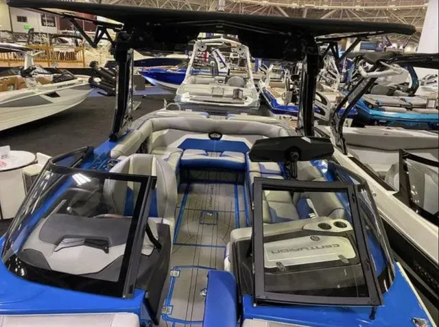 Slide: The Image of The image shows a modern 2023 Centurion Ri245 boat with blue and gray seating. - 5