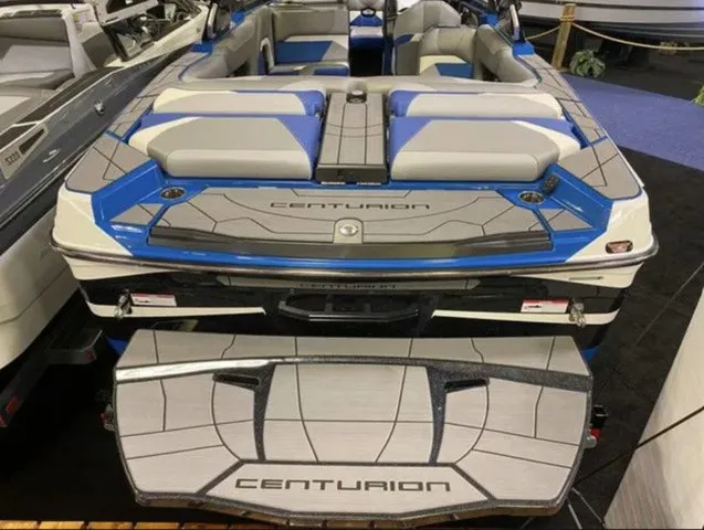 Slide: The Image of The image shows the rear of a 2023 Centurion Ri245 boat with blue and gray upholstery. - 7