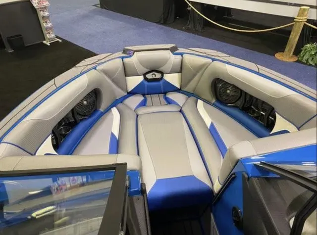 Slide: The Image of The image shows the bow area of a 2023 Centurion Ri245 boat with blue and gray upholstery. - 4