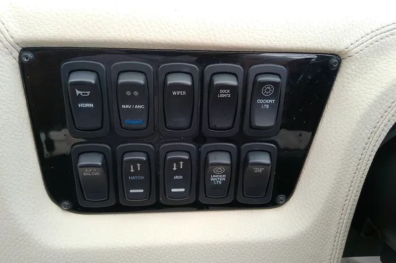 Slide: The Image of Control panel of a 2019 Regal 29 OBX boat with various switches. - 25