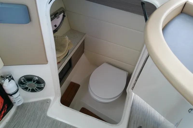 Slide: The Image of 2019 Regal 29 OBX boat interior with compact bathroom and toilet. - 23