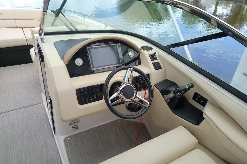 Slide: The Image of 2019 Regal 29 OBX boat cockpit with steering wheel and control panel. - 21