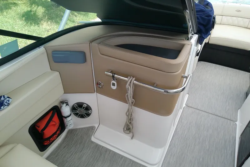 Slide: The Image of Interior of a 2019 Regal 29 OBX boat, featuring seating and storage areas. - 22