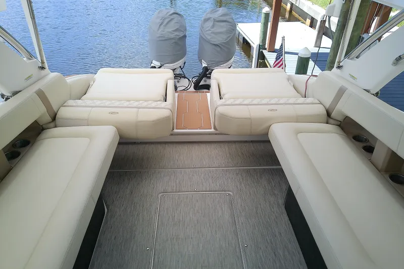 Slide: The Image of 2019 Regal 29 OBX boat interior with beige seating and twin outboard motors. - 14