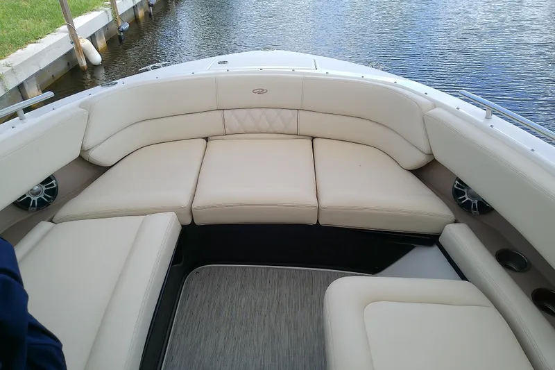 Slide: The Image of Luxurious seating on a 2019 Regal 29 OBX boat, docked by calm waters. - 35