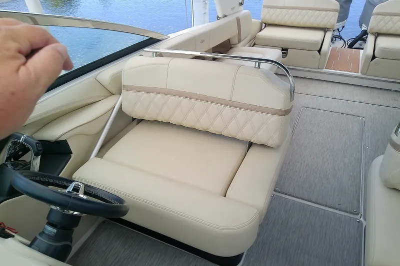Slide: The Image of 2019 Regal 29 OBX boat interior with beige seating and steering wheel. - 15