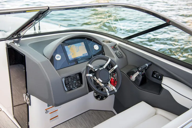 Slide: The Image of Manufacturer Provided Image: 2019 Regal 29 OBX boat dashboard with navigation screen and steering wheel. - 51