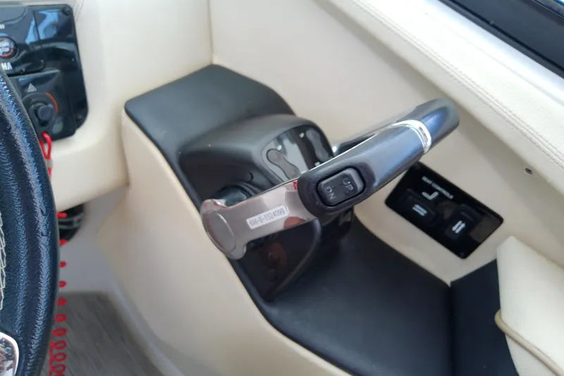 Slide: The Image of Control panel of a 2019 Regal 29 OBX boat, featuring throttle and steering controls. - 33