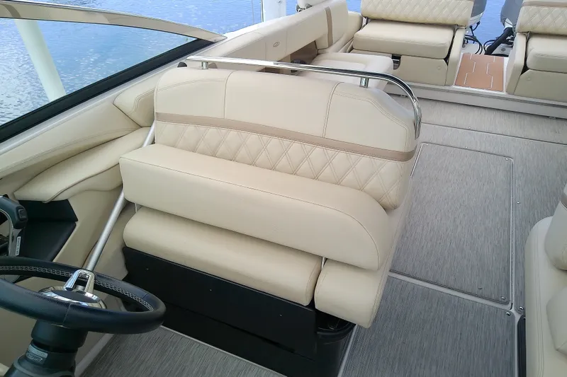 Slide: The Image of 2019 Regal 29 OBX boat interior with beige seating and steering wheel. - 17