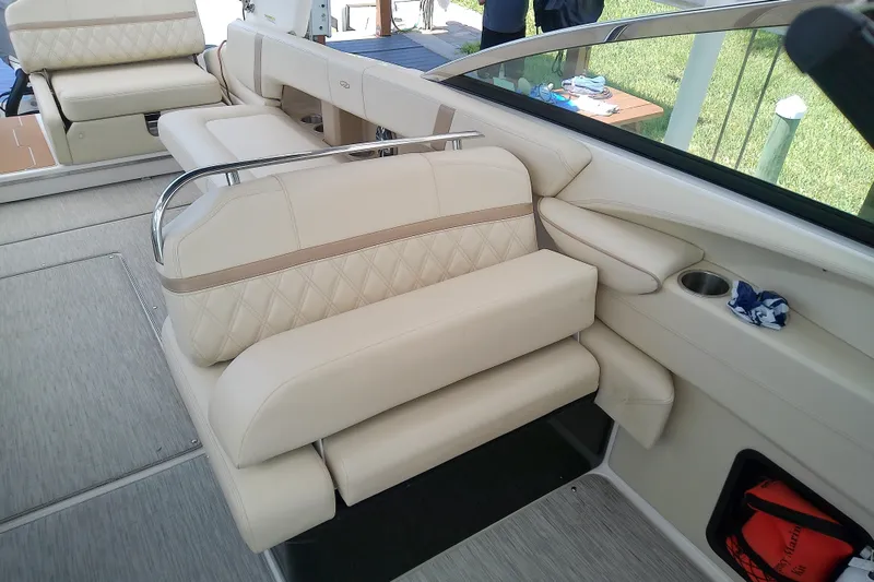 Slide: The Image of 2019 Regal 29 OBX boat interior with beige leather seating and cup holder. - 18