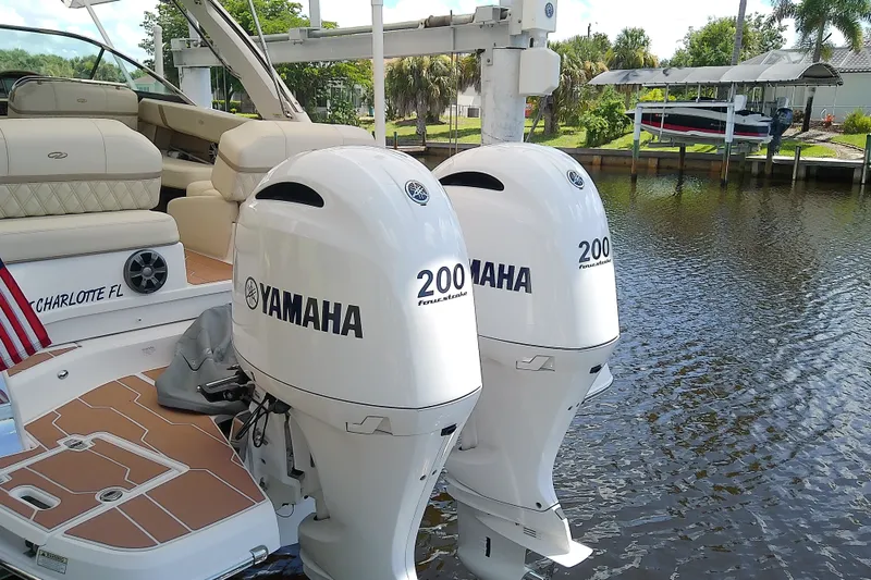 Slide: The Image of 2019 Regal 29 OBX boat with twin Yamaha 200 outboard engines docked by water. - 9