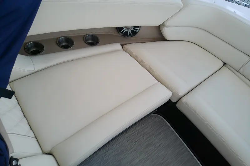 Slide: The Image of Luxurious seating area on a 2019 Regal 29 OBX boat with cup holders and speaker. - 36