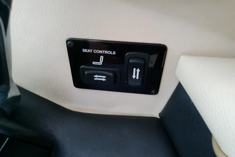 Slide: The Image of 2019 Regal 29 OBX seat controls with adjustment buttons on beige interior. - 34