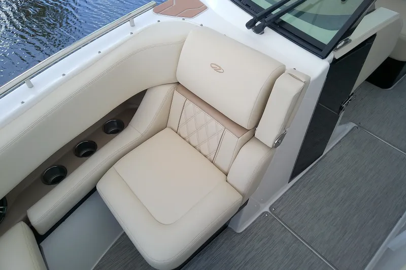 Slide: The Image of Luxurious seating on 2019 Regal 29 OBX boat with beige upholstery and cup holders. - 37