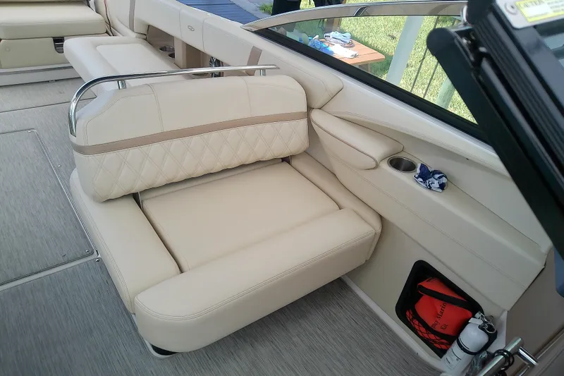 Slide: The Image of Luxurious seating on a 2019 Regal 29 OBX boat with beige upholstery and storage compartments. - 16
