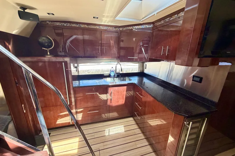 Slide: The Image of Luxurious kitchen interior of 2013 Regal 52 Sport Coupe yacht with sleek wood cabinetry. - 7