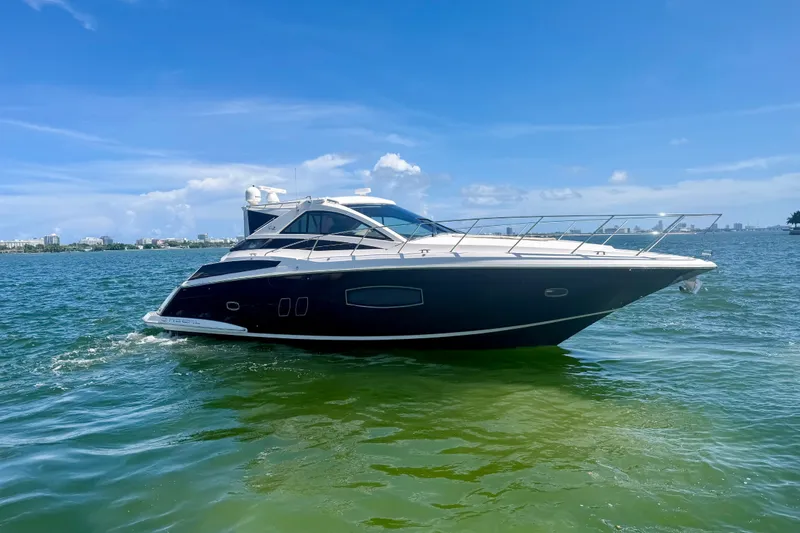 Slide: The Image of 2013 Regal 52 Sport Coupe yacht cruising on clear blue waters. - 2