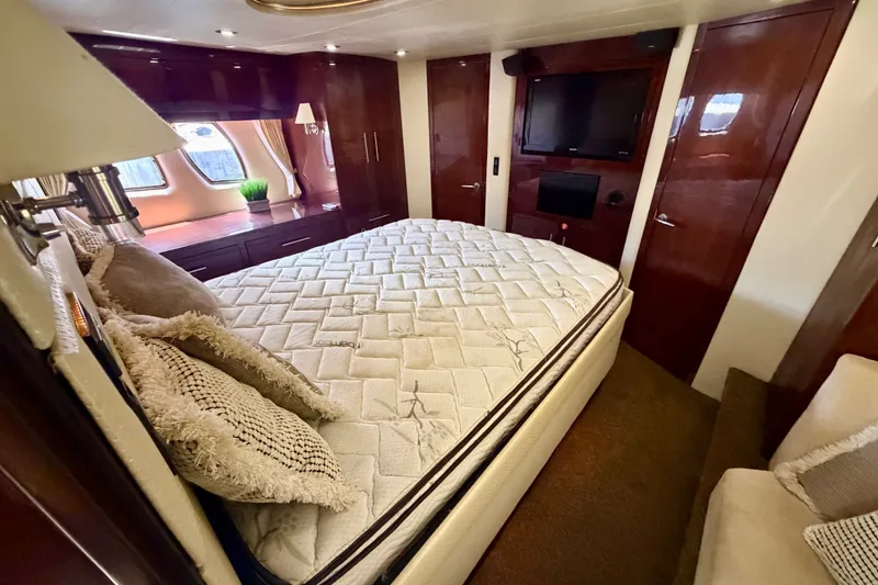 Slide: The Image of Luxurious bedroom interior of 2013 Regal 52 Sport Coupe yacht with elegant wood finishes. - 11