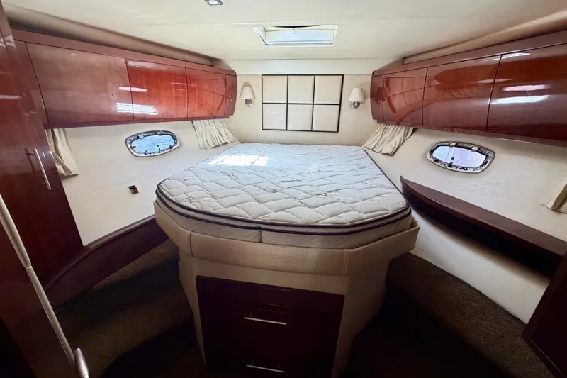 Slide: The Image of Luxurious cabin interior of 2013 Regal 52 Sport Coupe yacht with elegant wood finishes. - 13