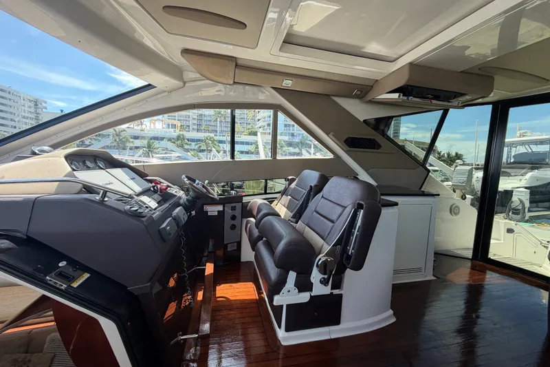 Slide: The Image of Interior of a 2013 Regal 52 Sport Coupe yacht with modern helm and seating. - 8