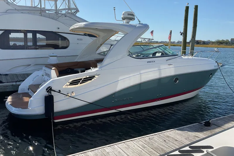 The Image of 2019 Rinker 290 Express Cruiser docked at marina, side view. - 0