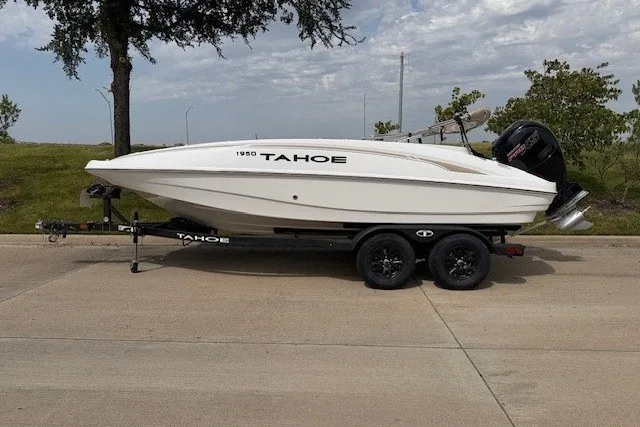 The Image of 2026 Tahoe 1950 boat on trailer, parked on a road, under a cloudy sky. - 17